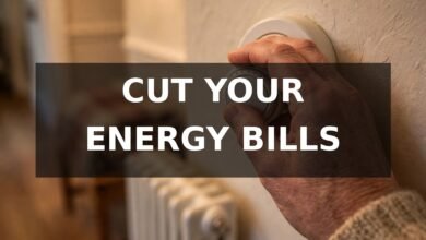 Hand turning down a thermostat — how to save money on energy bills UK