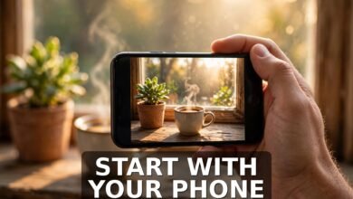 Hand holding smartphone photographing morning coffee and plant - how to sell stock photos online for beginners